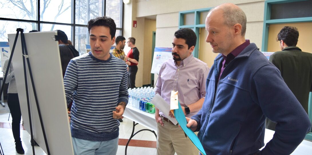 ITE members participating in the CME Poster competition - A group of people at a poster session.