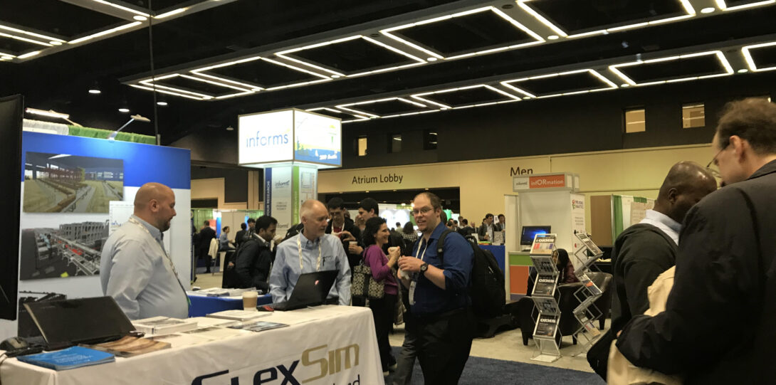 INFORMS 2019 -  A large conference hall with multiple booths set up.